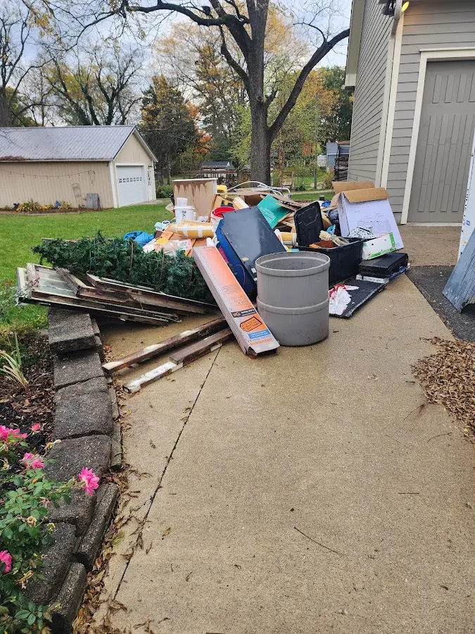 Dumpster being loaded with debris for Estate Cleanout Dumpster Rental in Roma